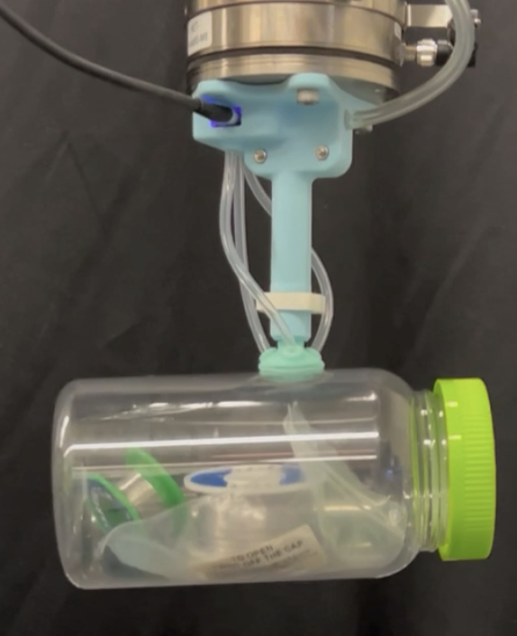 Smart suction cup prototype lifting a bottle